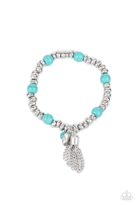 Paparazzi Accessories Whimsically Wanderlust - Blue An earthy collection of hammered silver beads and round turquoise stones are threaded along a stretchy band around the wrist. A dainty silver tassel, hammered silver disc, and a turquoise stone swing fro