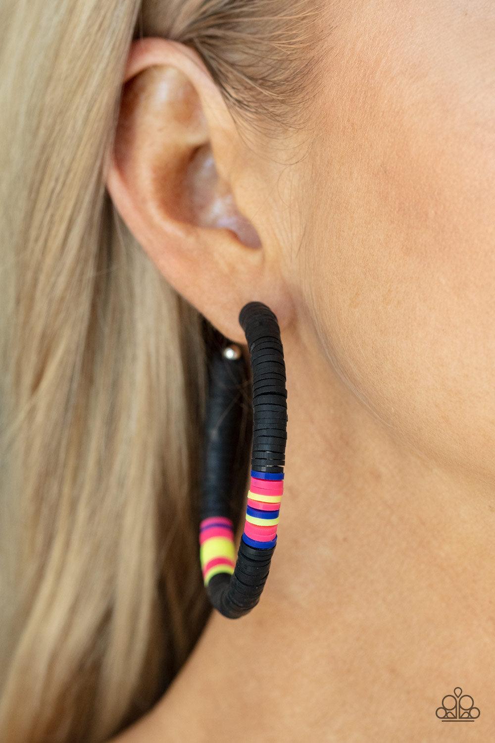 Paparazzi Accessories Colorfully Contagious - Black Rubbery black, pink, blue, and yellow bands are threaded along an oversized silver hoop, creating a courageous pop of color. Earring attaches to a standard post fitting. Hoop measures approximately 2 1/4