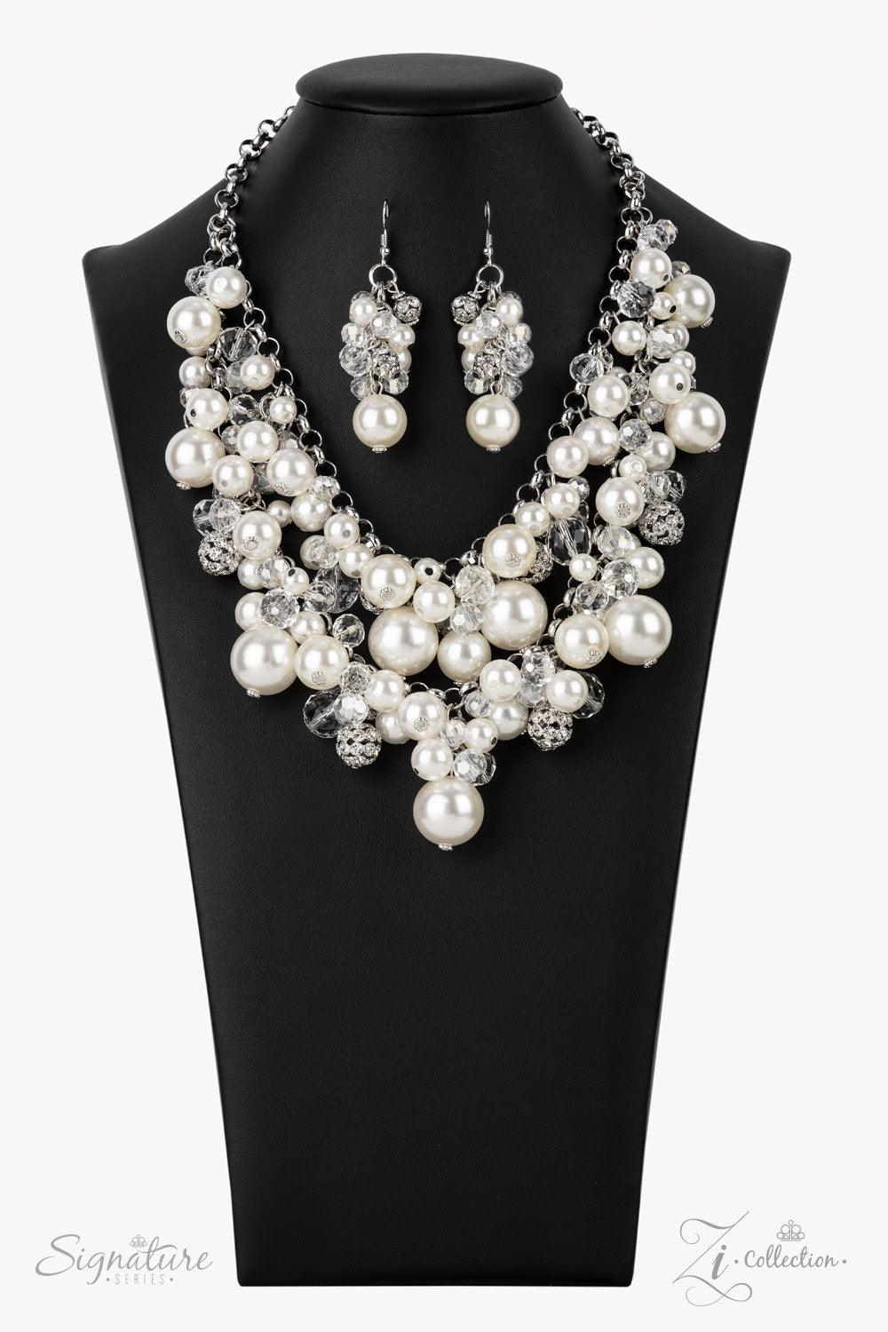 Paparazzi Accessories The Janie An elegantly effervescent collection of oversized pearls, glassy crystal-like beads, and white rhinestone studded silver ornaments effortlessly clusters along two bold silver chains below the collar. The bubbly bunched acce