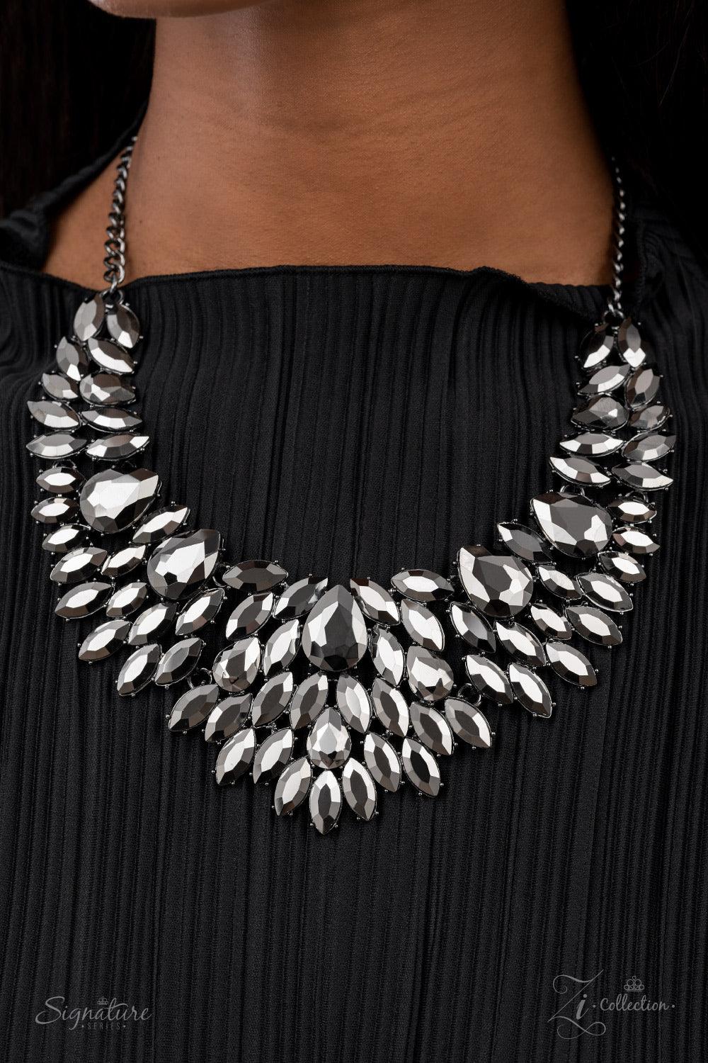 Paparazzi Accessories The Tanisha A smoldering collection of oversized teardrop and marquise cut hematite rhinestones daringly fan out from the collar, coalescing into intense interconnected frames. The dauntless display of dazzle locks in place, creating
