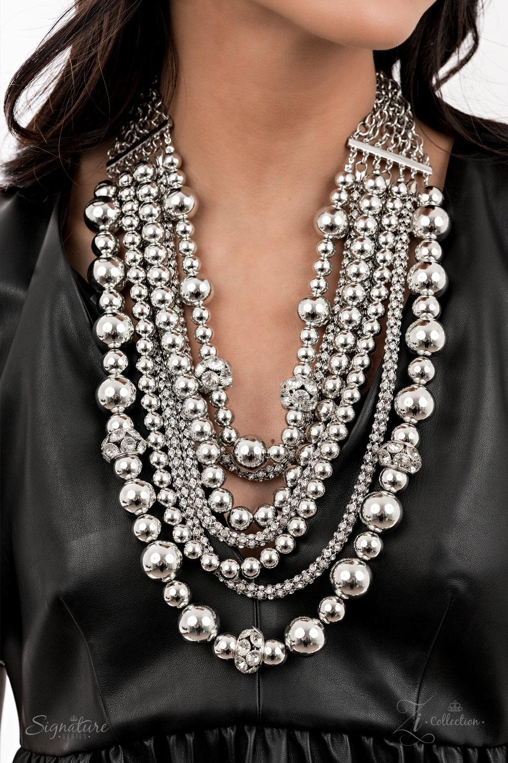 Paparazzi Accessories The Liberty Held together by rectangular silver frames, a couture-clutching collection of oversized silver beads interspersed with white rhinestone encrusted ornaments alternates with interlocking rows of white rhinestone encrusted c