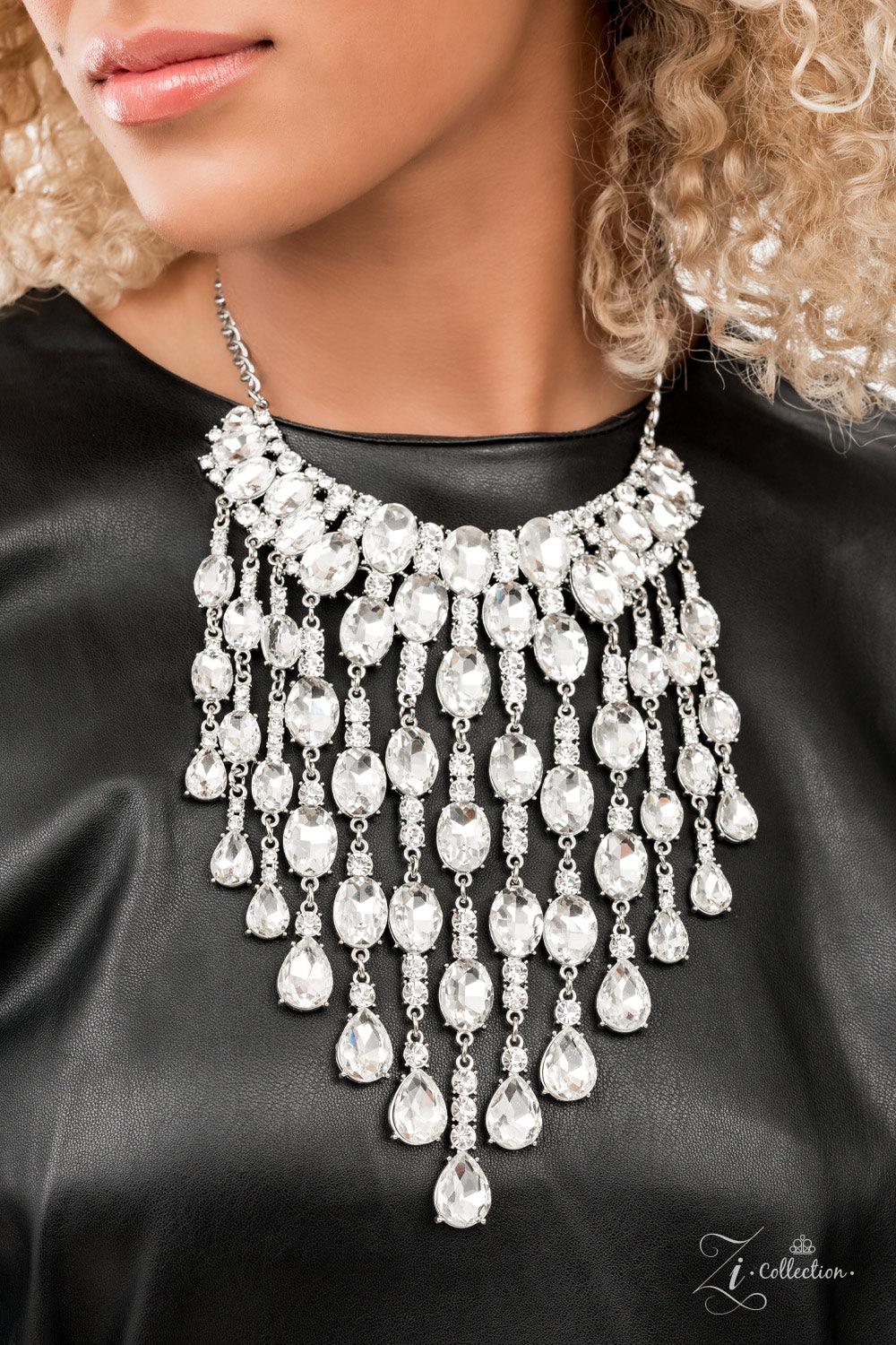 Paparazzi Accessories Majestic An intoxicating display of oversized oval and teardrop white gems dramatically drip below the collar. Enhanced with majestically mismatched white rhinestone fittings, the twinkly tassels cascade from the bottom of overloaded