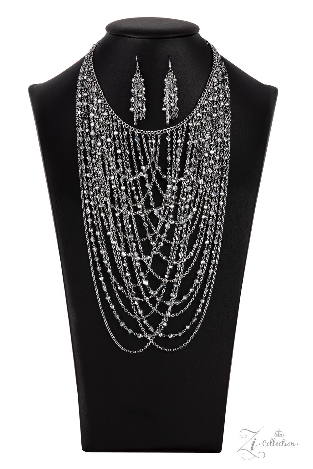 Paparazzi Accessories Enticing An entrancing collection of raw cut, faceted, and crystal-like silver and hematite beads delicately connect into glitzy strands that dauntlessly drape across the chest. Intermixed with plain silver chains, the swooping layer