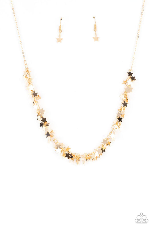 Paparazzi Accessories Starry Anthem - Gold A glistening collection of dainty gold star charms delicately cluster on a classic gold chain, creating a stellar fringe below the collar. Features an adjustable clasp closure. Sold as one individual necklace. In