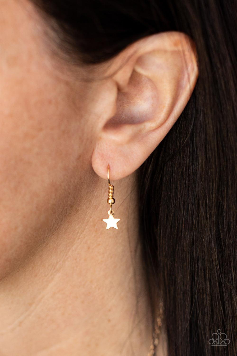 Paparazzi Accessories Starry Anthem - Gold A glistening collection of dainty gold star charms delicately cluster on a classic gold chain, creating a stellar fringe below the collar. Features an adjustable clasp closure. Sold as one individual necklace. In