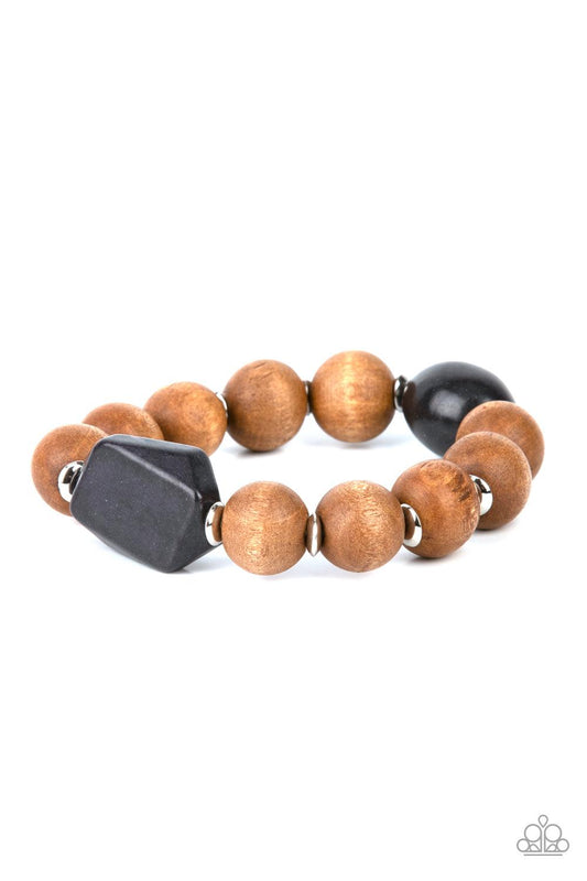 Paparazzi Accessories Abundantly Artisan - Black Oversized brown wooden beads and mismatched black stone accents are separated by dainty silver discs and threaded along a stretchy band, creating an earthy centerpiece around the wrist. Sold as one individu