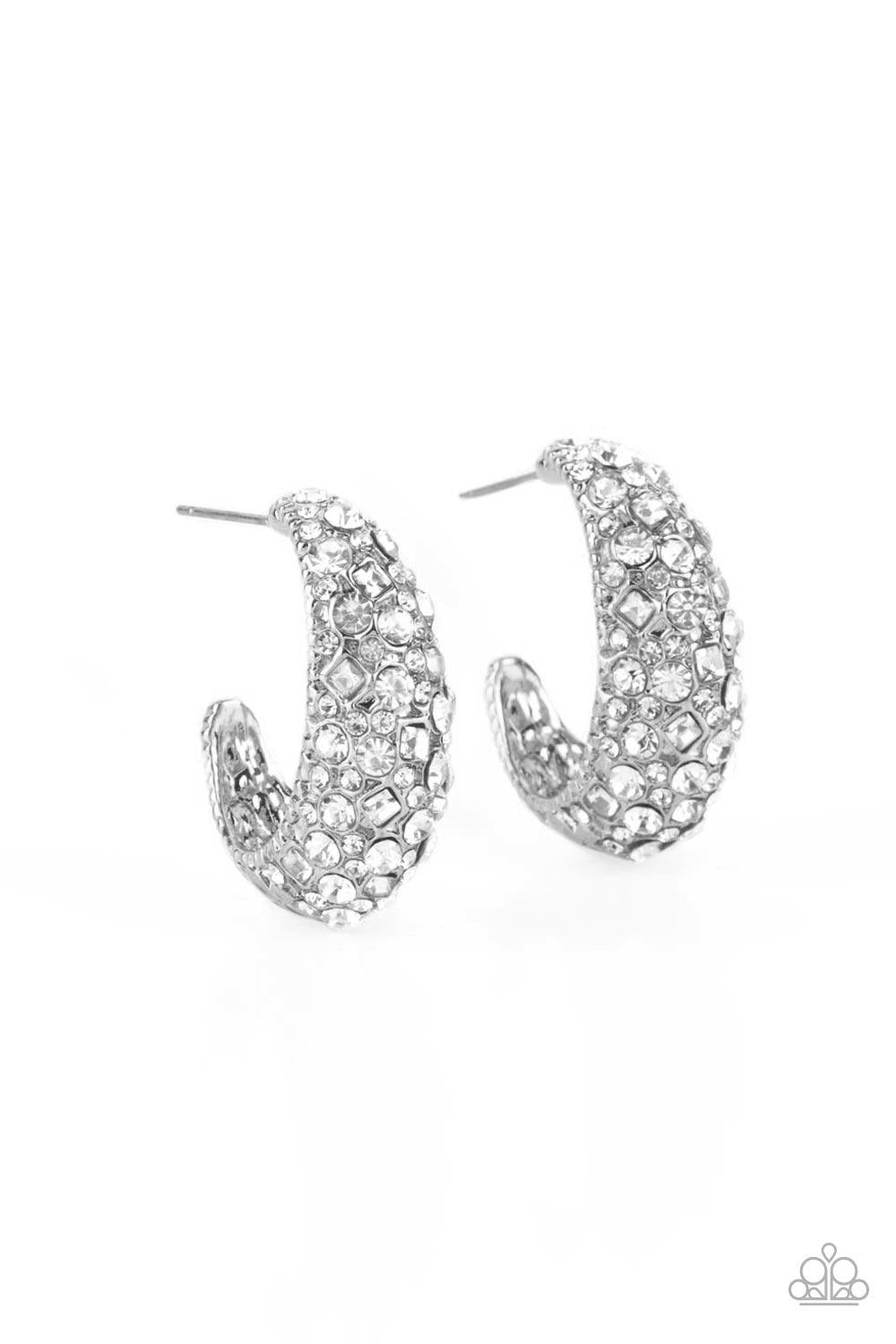 Paparazzi Accessories Glamorously Glimmering - White Featuring a beveled surface, a thick hammered silver hoop is haphazardly encrusted in round and square white rhinestones for a glamorously glittery finish. Earring attaches to a standard post fitting. H