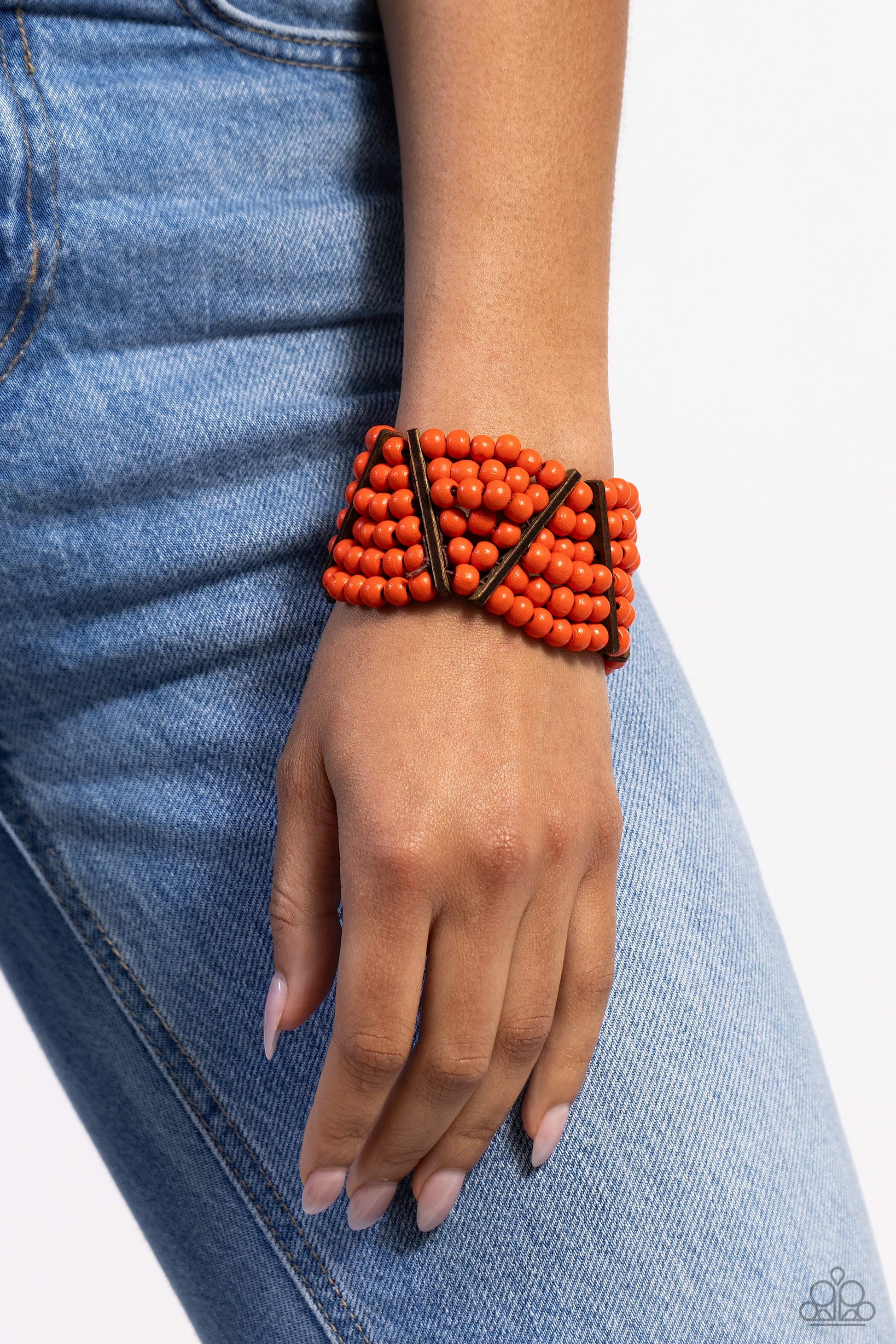 Paparazzi Accessories Way Off TROPIC - Orange Stacked layers of vibrant orange wooden beads are threaded along stretchy bands making a bold statement. Slender wooden bars are woven in on an angle and lean in opposite directions as they work their way arou