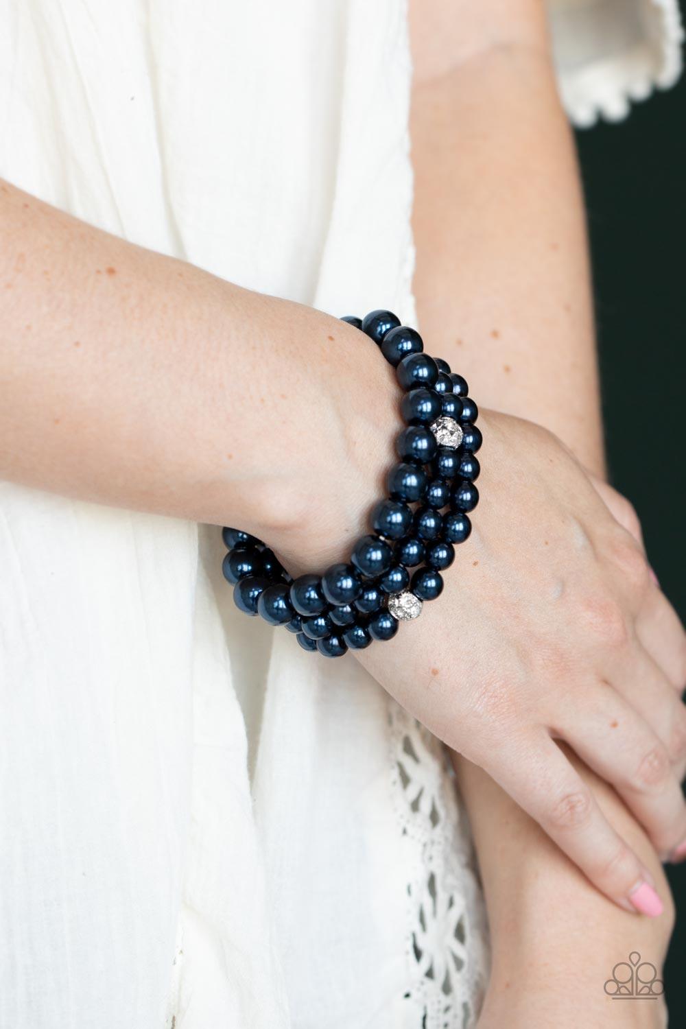 Paparazzi Accessories Here Comes The Heiress - Blue Infused with white rhinestone encrusted silver beads, a bubbly collection of mismatched blue pearls are threaded along stretchy bands around the wrist for a vintage inspired layered look. Sold as one set