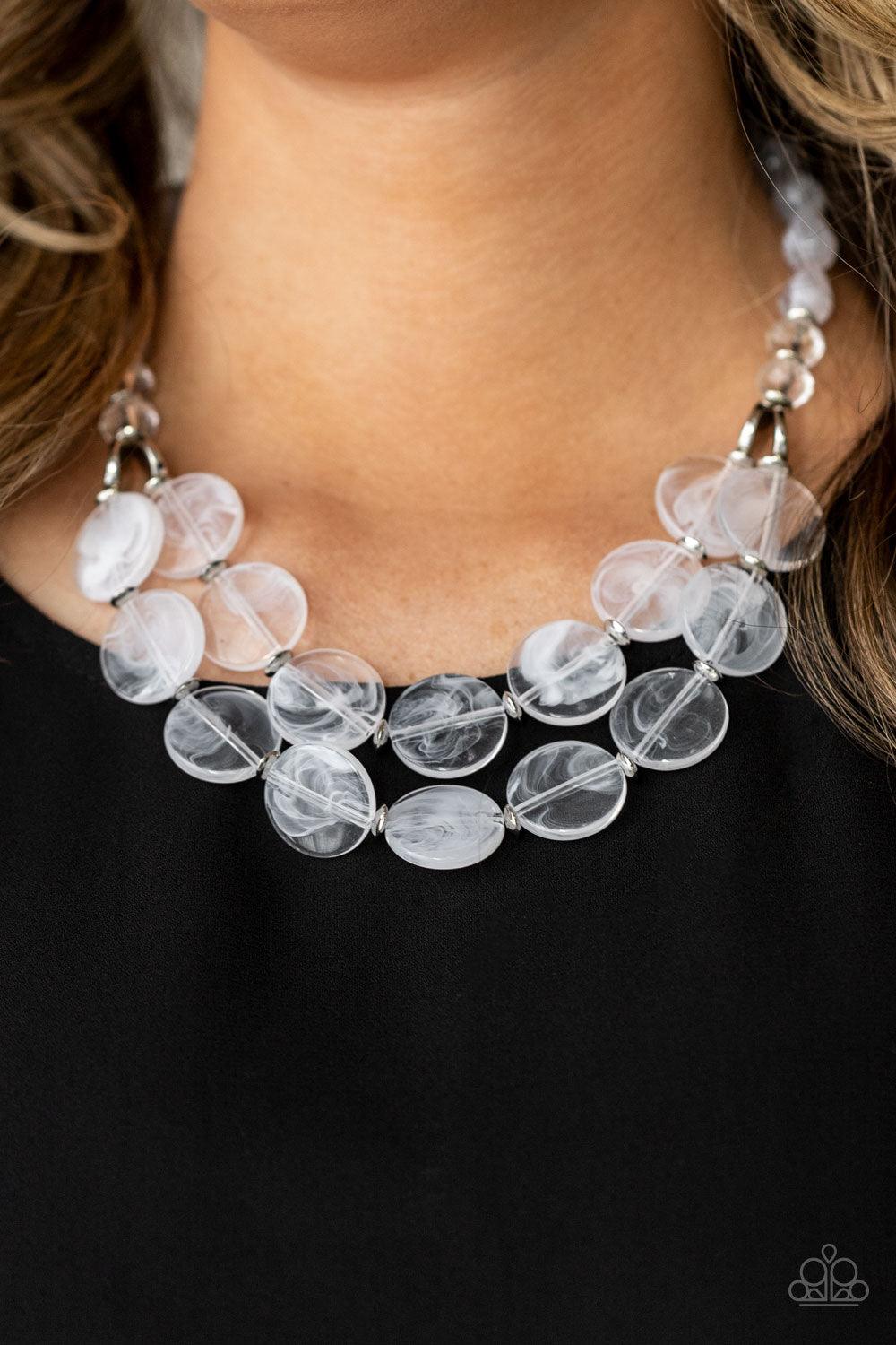 Paparazzi Accessories Beach Day Demure - White Intermixed with glassy crystal-like beads and shiny silver accents, mismatched cloudy, glassy, and opaque white teardrop and disc beads layer below the collar for a classic pop of neutral color. Features an a