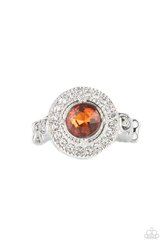 Paparazzi Accessories Targeted Timelessness - Brown Featuring a pronged silver fitting, an oversized topaz gem sits atop a radiant ring of glassy white rhinestones for a timeless fashion. Features a dainty stretchy band for a flexible fit. Sold as one ind