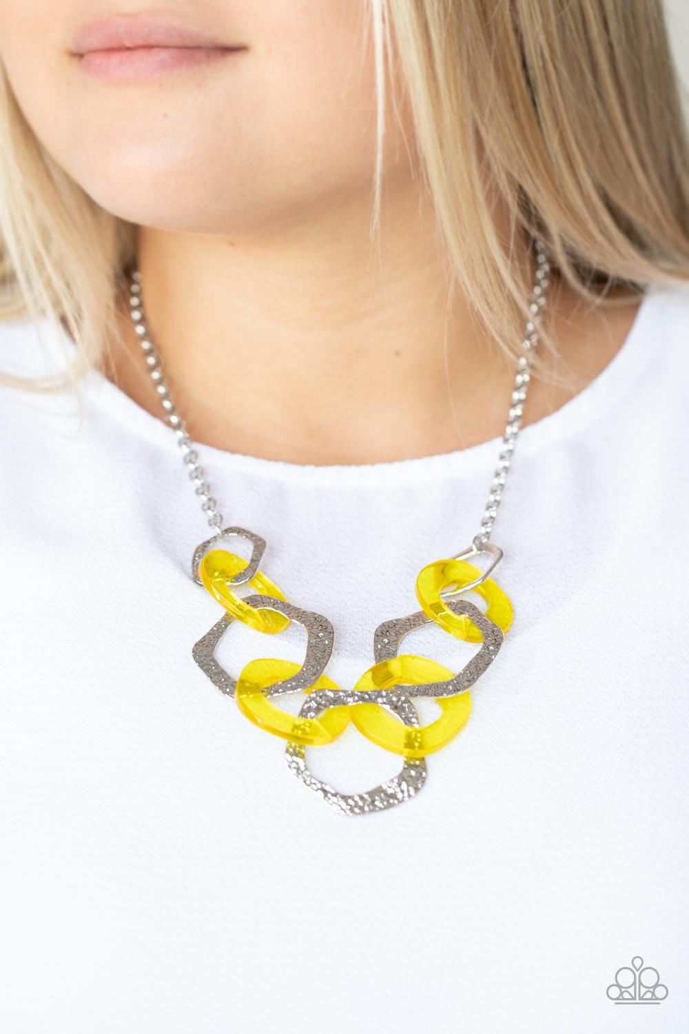 Paparazzi Accessories Urban Circus - Yellow An asymmetrical assortment of Illuminating acrylic rings and hammered silver hoops boldly interlock below the collar, creating an intense pop of color. Features an adjustable clasp closure. Sold as one individua