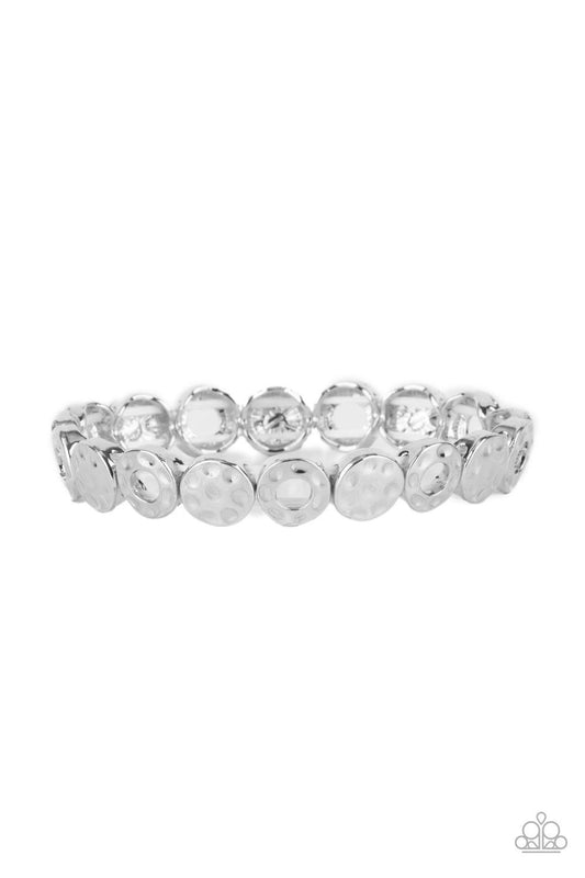 Paparazzi Accessories Metro Metalsmith - Silver A hammered collection of silver rings and discs are threaded along stretchy bands around the wrist, creating a dainty metallic centerpiece. Sold as one individual bracelet. Jewelry