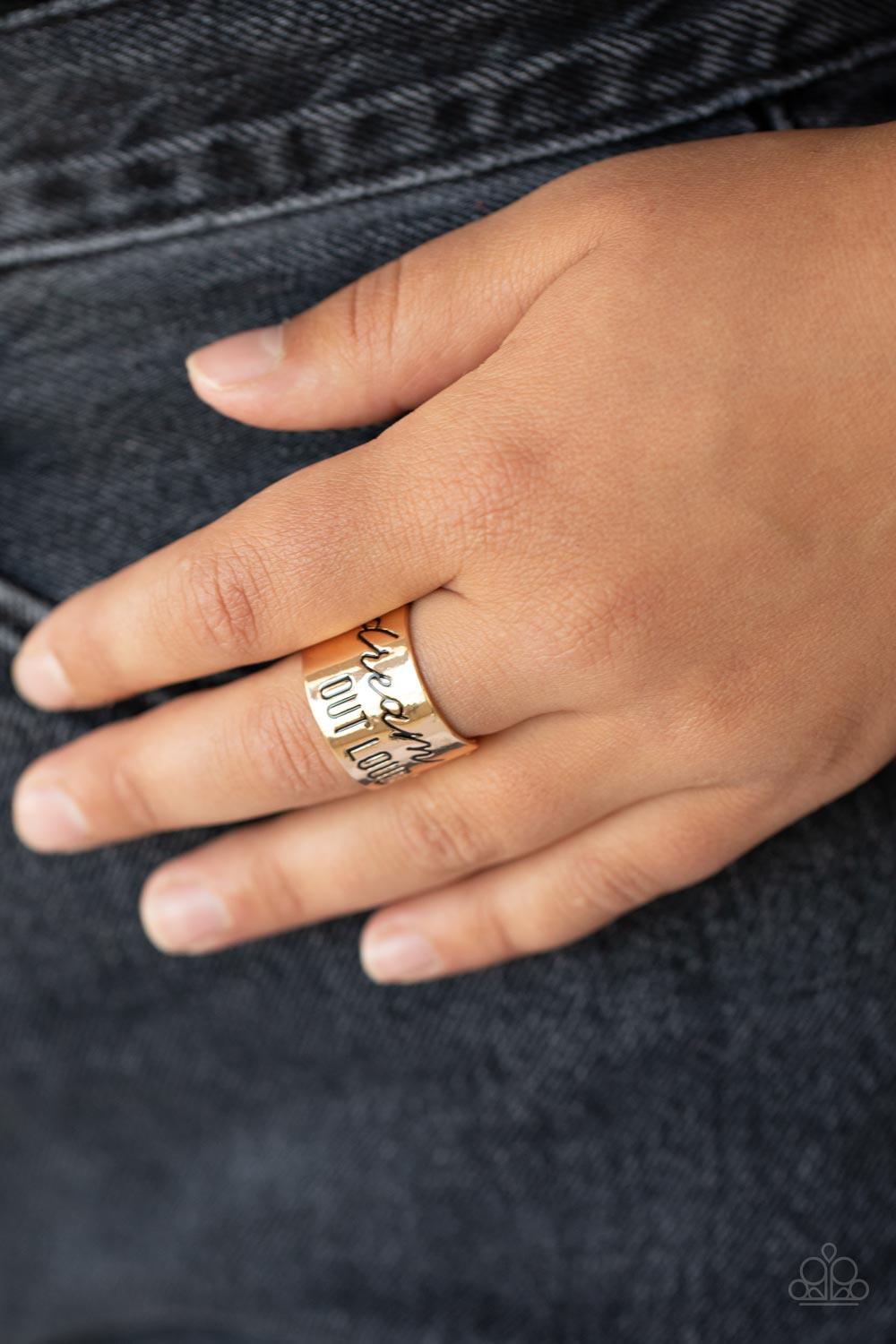 Paparazzi Accessories Dream Louder - Gold The front of a thick gold band is stamped in the phrase, "Dream out loud," creating an inspirational centerpiece across the finger. Features a stretchy band for a flexible fit. Sold as one individual ring. Jewelry