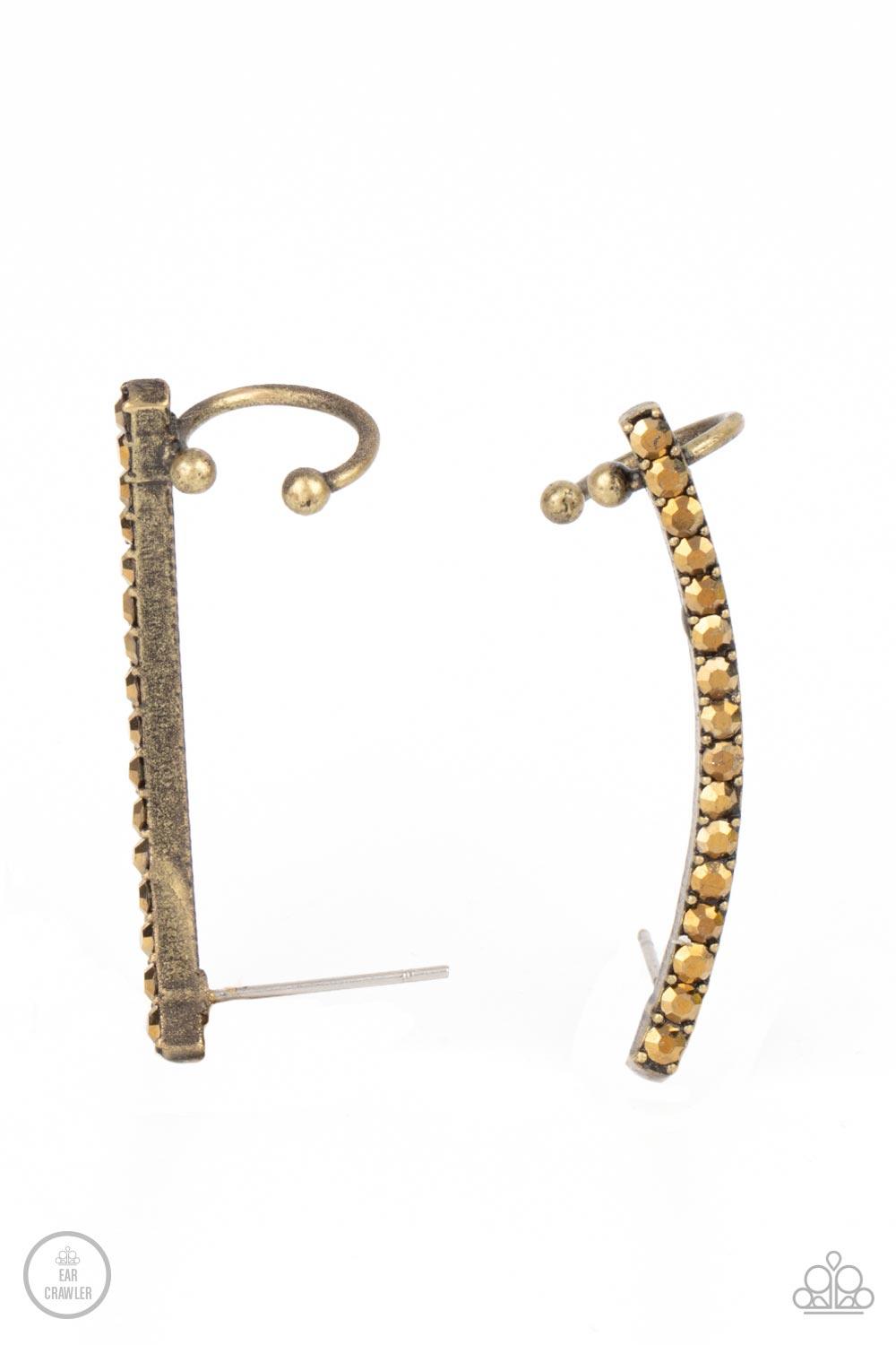 Paparazzi Accessories Give Me The SWOOP - Brass Post Earring A dainty row of glitzy aurum rhinestones is encrusted along a gritty brass bar that swoops up the ear for a smoldering style. Features a dainty cuff attached to the top for a secure fit. Sold as