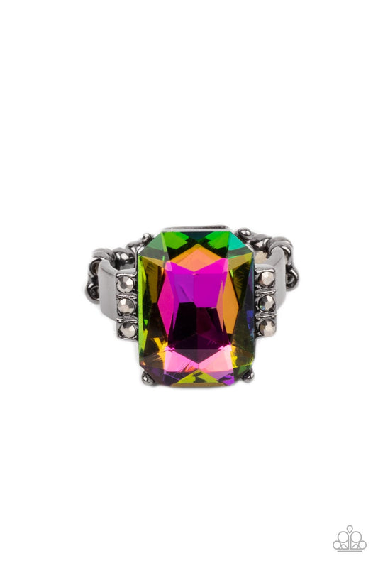 Paparazzi Accessories Epic Proportions - Multi Flanked by stacks of dainty hematite rhinestones, an oversized faceted oil spill emerald cut gem is pressed into the center of a sleek gunmetal frame, resulting in a dramatic centerpiece atop the finger. Feat