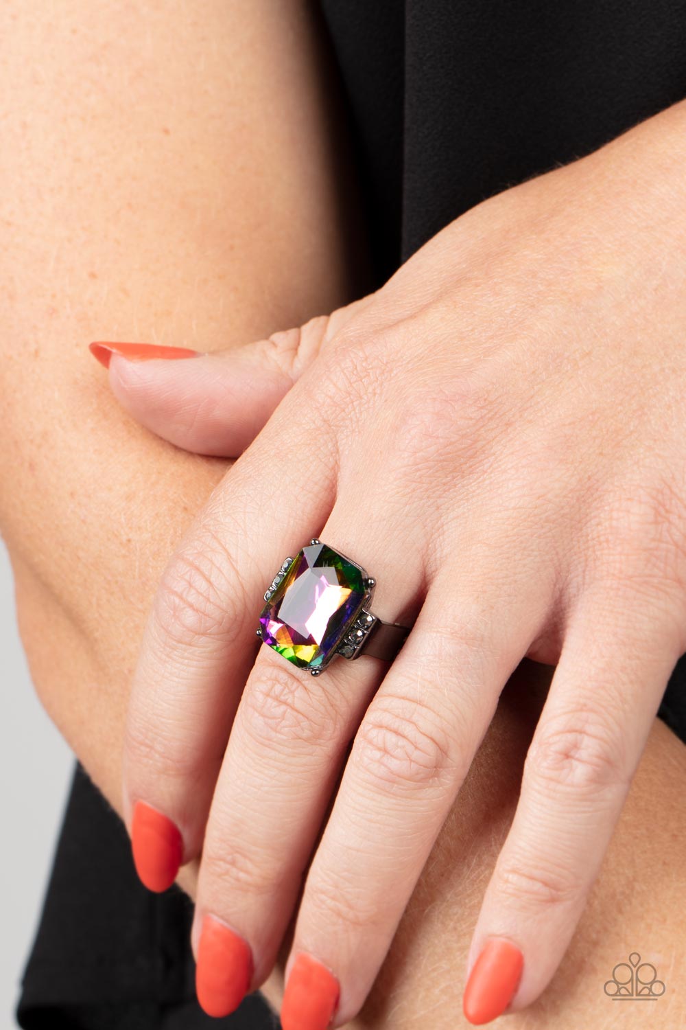 Paparazzi Accessories Epic Proportions - Multi Flanked by stacks of dainty hematite rhinestones, an oversized faceted oil spill emerald cut gem is pressed into the center of a sleek gunmetal frame, resulting in a dramatic centerpiece atop the finger. Feat