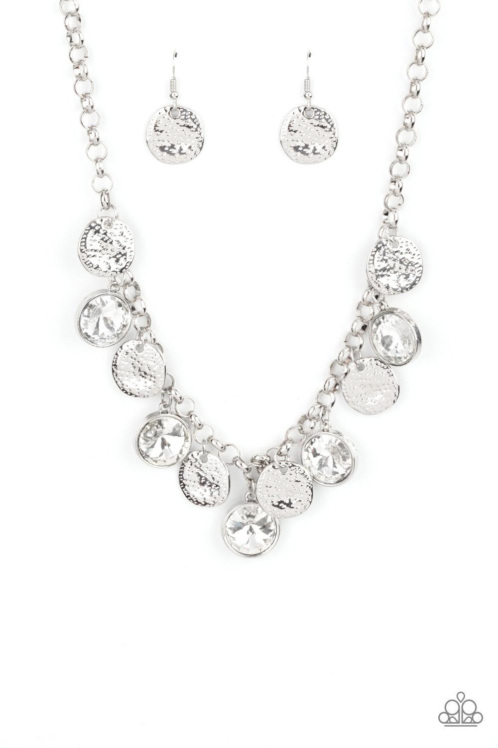 Paparazzi Accessories Spot On Sparkle - White A blinding collection of hammered silver discs and oversized white gems swing from the bottom of a bold silver chain, creating noise-making sparkle below the collar. Features an adjustable clasp closure. Sold