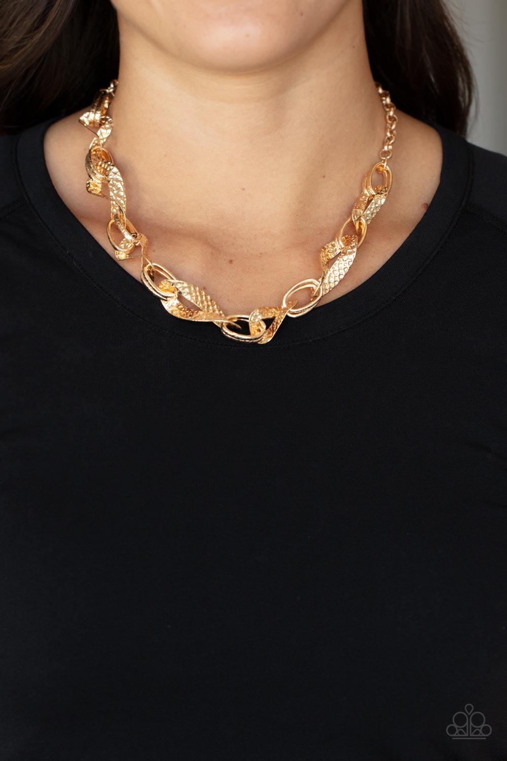 Paparazzi Accessories METAL of Honor - Gold Hammered and embossed in geometric detail, pairs of gold links connect with twisting gold oval frames below the collar for an edgy, but refined look. Features an adjustable clasp closure. Sold as one individual