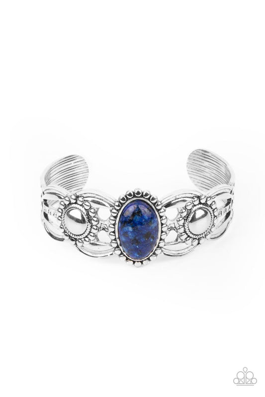 Paparazzi Accessories Solar Solstice - Blue An oval blue stone is pressed into the center of a studded silver frame atop an airy silver cuff embellished in studded sun-like frames for an earthy pop of seasonal color around the wrist. Sold as one individua