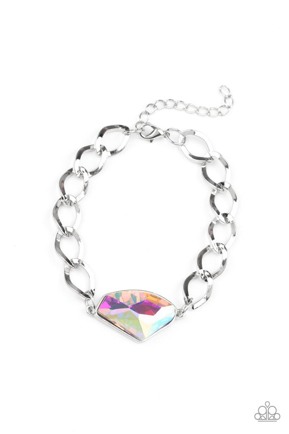 Paparazzi Accessories Galactic Grunge - Multi Featuring a UV shimmer, a raw cut multi gem is pressed into a sleek silver frame that attaches to a bold silver chain around the wrist for a glitzy grunge fashion. Features an adjustable clasp closure. Sold as