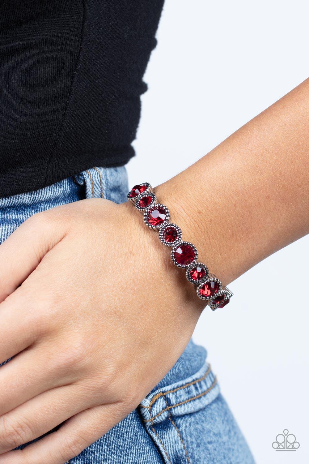 Paparazzi Accessories Phenomenally Perennial - Red Featuring mismatched silver studded fittings, an oversized collection of sparkly red rhinestones are threaded along a stretchy band around the wrist for a fiery pop of color. Sold as one individual bracel