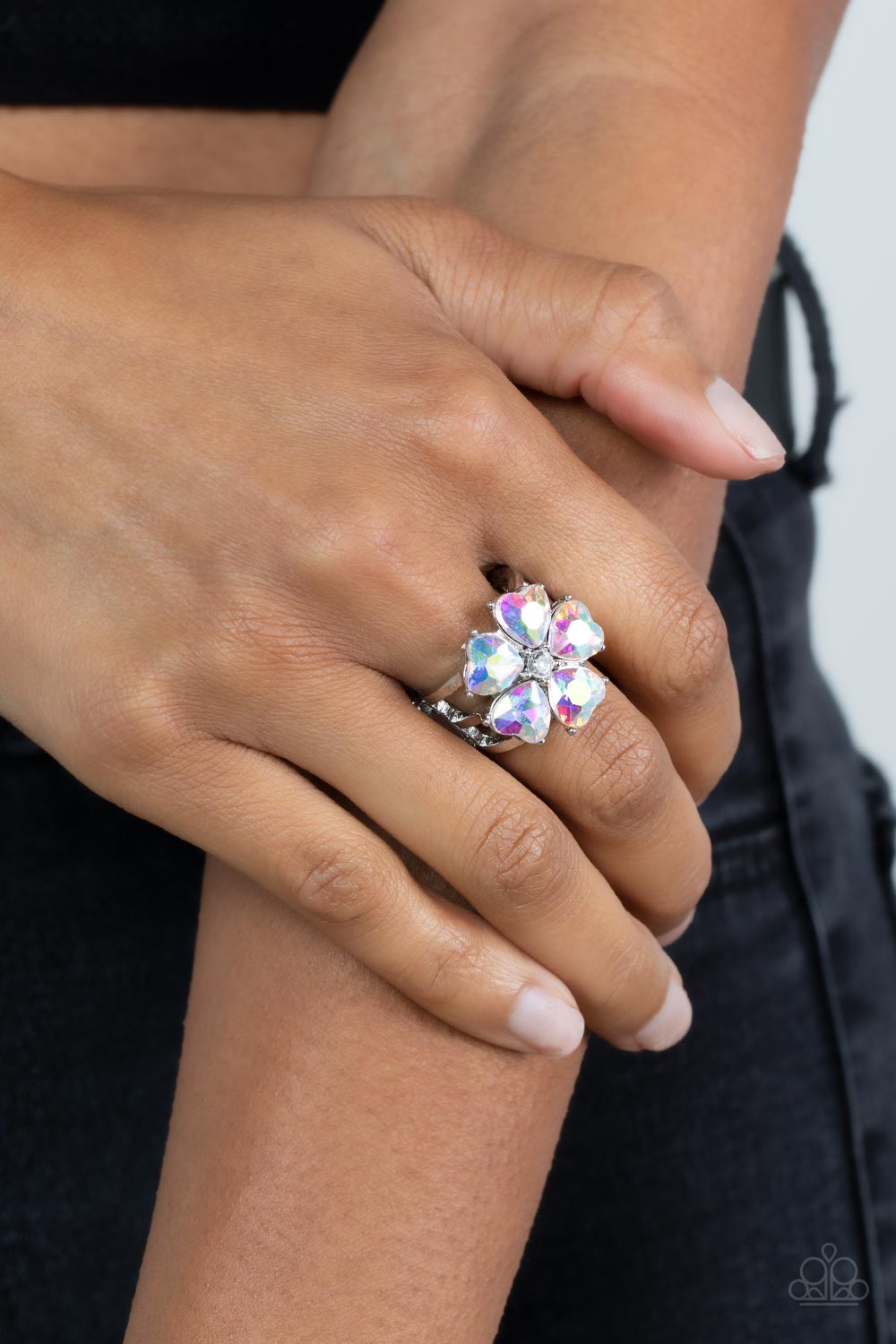 Paparazzi Accessories Minnesota Magic - Multi Glittery heart shaped iridescent rhinestones bloom from a dainty white rhinestone center, creating a sparkly floral centerpiece atop layered silver bands. Features a stretchy band for a flexible fit. Sold as o