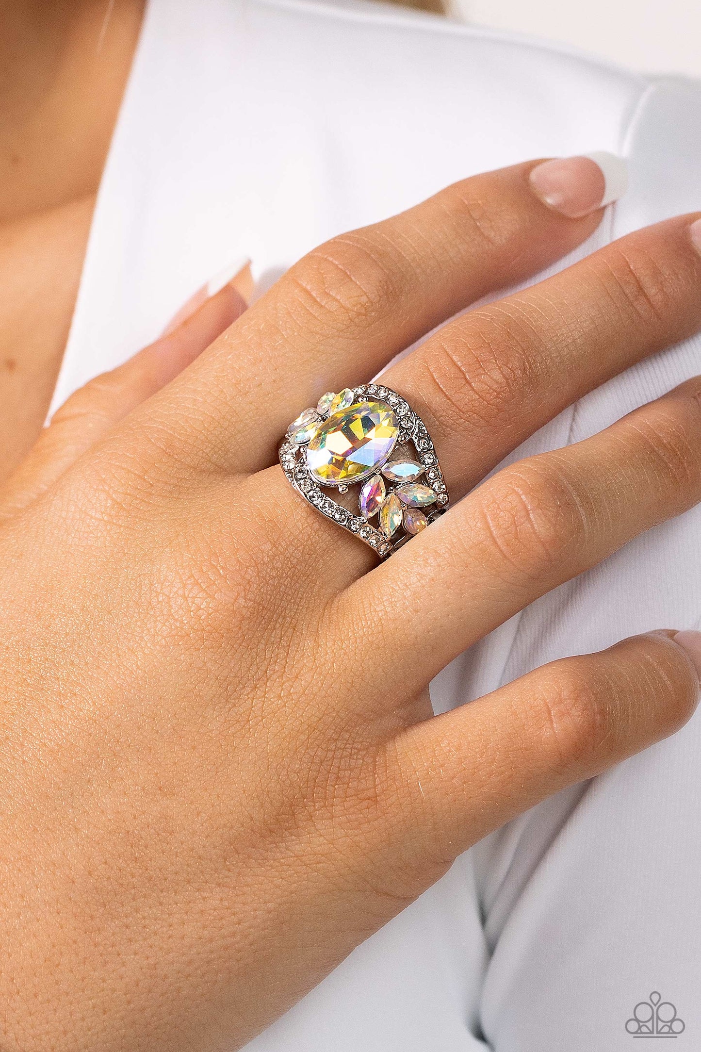 Paparazzi Accessories Cosmic Clique - Multi Bordered in dainty rows of glassy white rhinestones, leafy iridescent rhinestones bloom from a dramatically oversized iridescent rhinestone that coalesces into a glamorous centerpiece atop the finger. Features a