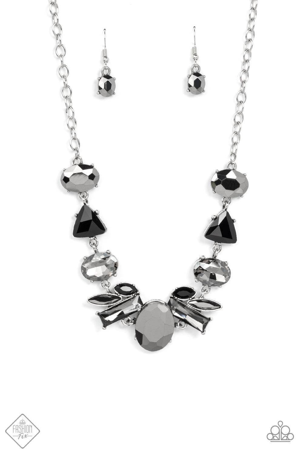 Paparazzi Accessories Modern Day Marvel - Silver Anchored by a glassy oval hematite gem, a mismatched collection of lustrous hematite, smoky, and black rhinestones in various modern shapes and sizes link together across the collar. The gritty display give