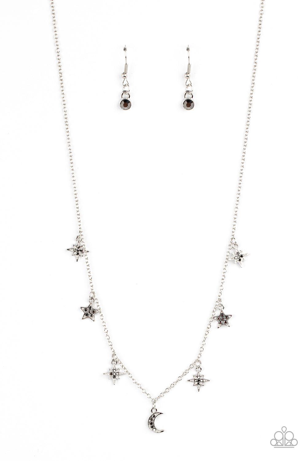 Paparazzi Accessories Cosmic Runway - Silver Dotted with dainty hematite rhinestones, a stellar collection of silver moon and star charms swing from a dainty silver chain below the collar, creating a cosmic fringe. Features an adjustable clasp closure. So