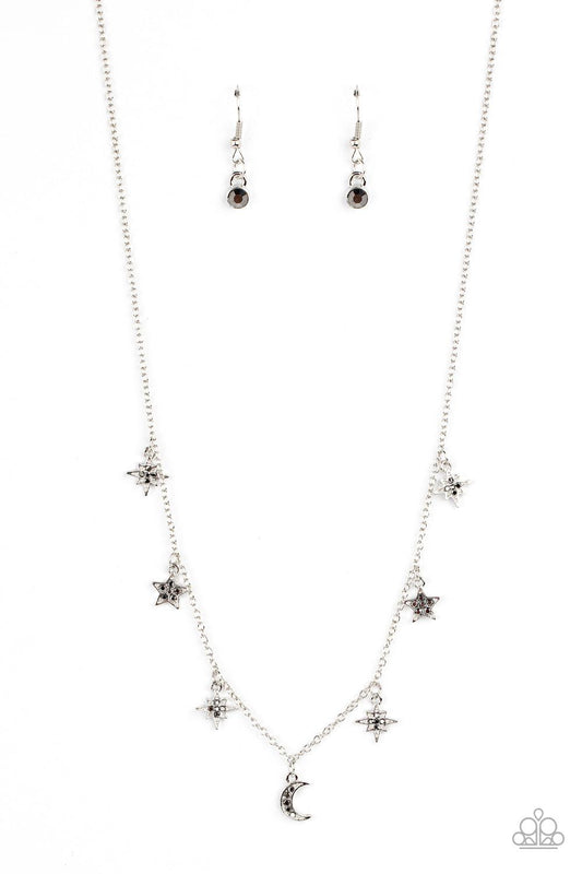 Paparazzi Accessories Cosmic Runway - Silver Dotted with dainty hematite rhinestones, a stellar collection of silver moon and star charms swing from a dainty silver chain below the collar, creating a cosmic fringe. Features an adjustable clasp closure. So