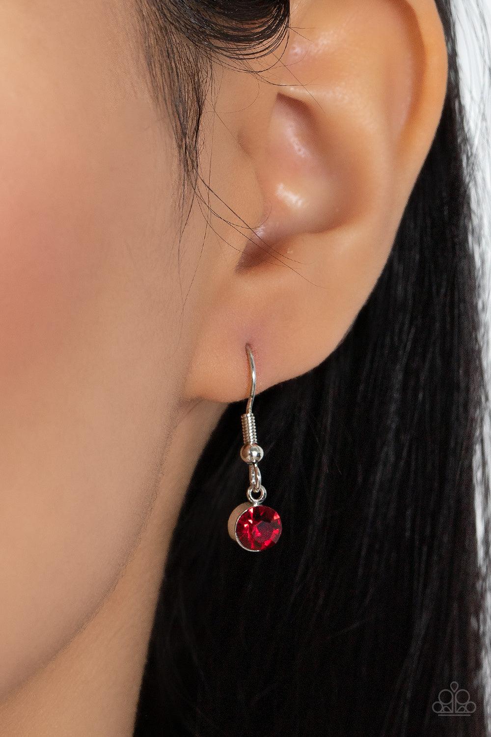 Paparazzi Accessories Material Girl Glamour - Red Encased in sleek silver fittings, elegant cut fiery red rhinestones delicately connect below the collar. An oversized red rhinestone adorns to the middle of the glittery strand, creating a sparkly centerpi