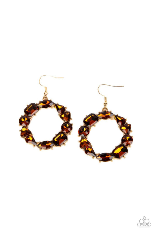 Paparazzi Accessories GLOWING in Circles - Brown Featuring glistening gold fittings, a regal assortment of round, triangular, teardrop, marquise, and emerald cut topaz rhinestones delicately coalesce into a jaw-dropping hoop. Earring attaches to a standar