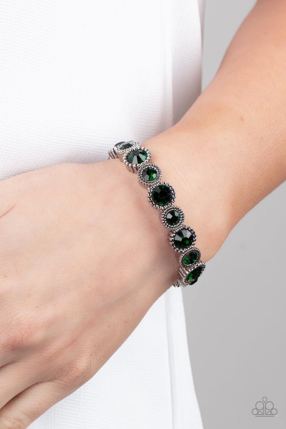 Paparazzi Accessories Phenomenally Perennial - Green Sparkling green gems are encased in studded silver frames. Varying in size, smaller gems alternate with larger gems along stretchy bands around the wrist for a dramatic look. Sold as one individual brac