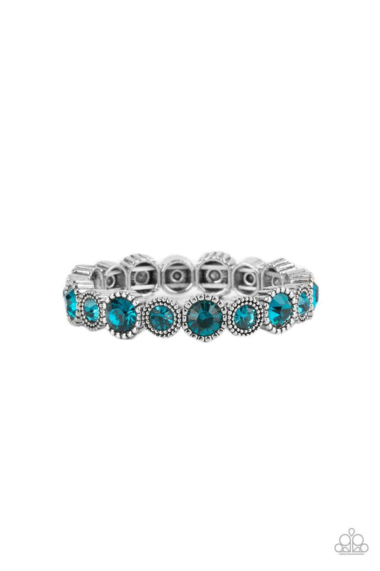 Paparazzi Accessories Phenomenally Perennial - Blue Sparkling blue gems, the color of the ocean, are encased in studded silver frames. Varying in size, smaller gems alternate with larger gems along stretchy bands around the wrist for a dramatic look. Sold