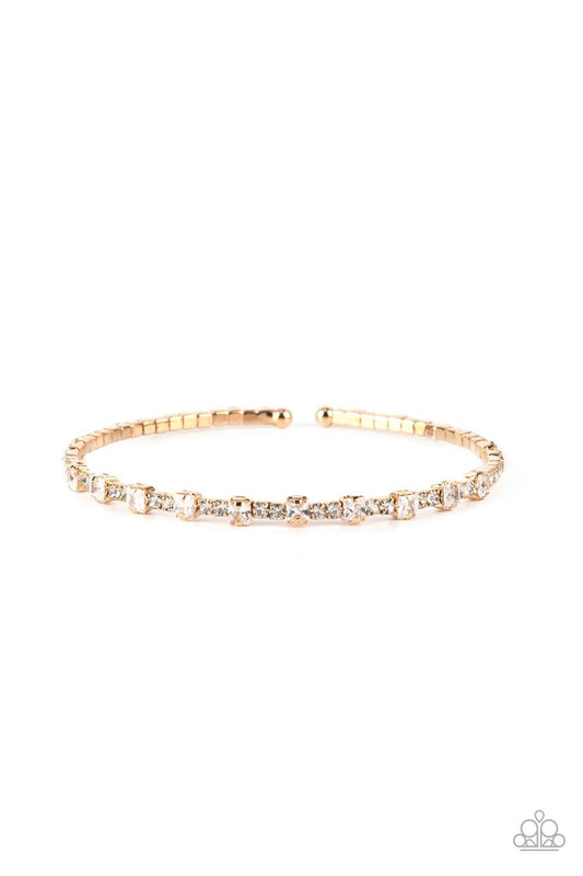 Paparazzi Accessories Timelessly Tiny - Gold Featuring sleek gold fittings, a classic band of dainty white rhinestones is interrupted with square cut white rhinestones, adding a timeless twist to the stackable cuff. Sold as one individual bracelet. Bracel