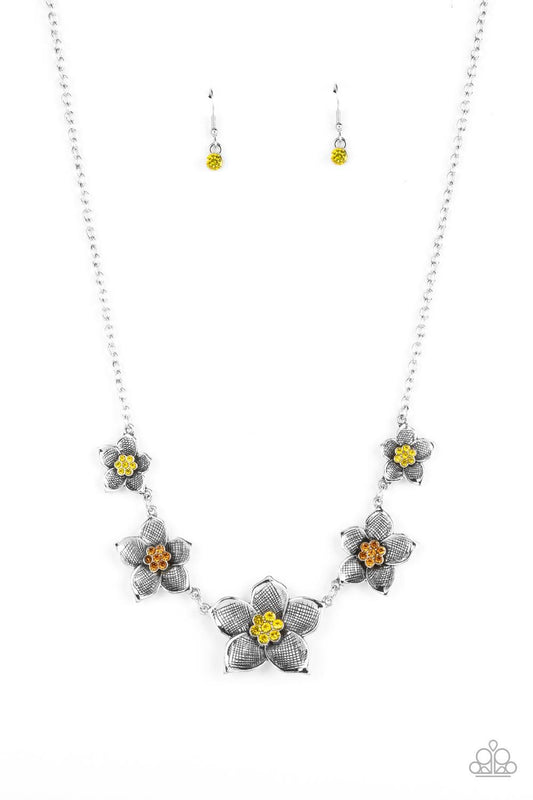 Paparazzi Accessories Wallflower Wonderland - Yellow Gradually increasing in size, textured silver floral frames featuring yellow and orange rhinestone encrusted centers delicately alternate below the collar for a fabulously floral fashion. Features an ad