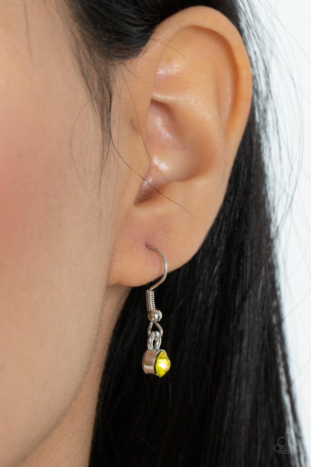 Paparazzi Accessories Wallflower Wonderland - Yellow Gradually increasing in size, textured silver floral frames featuring yellow and orange rhinestone encrusted centers delicately alternate below the collar for a fabulously floral fashion. Features an ad