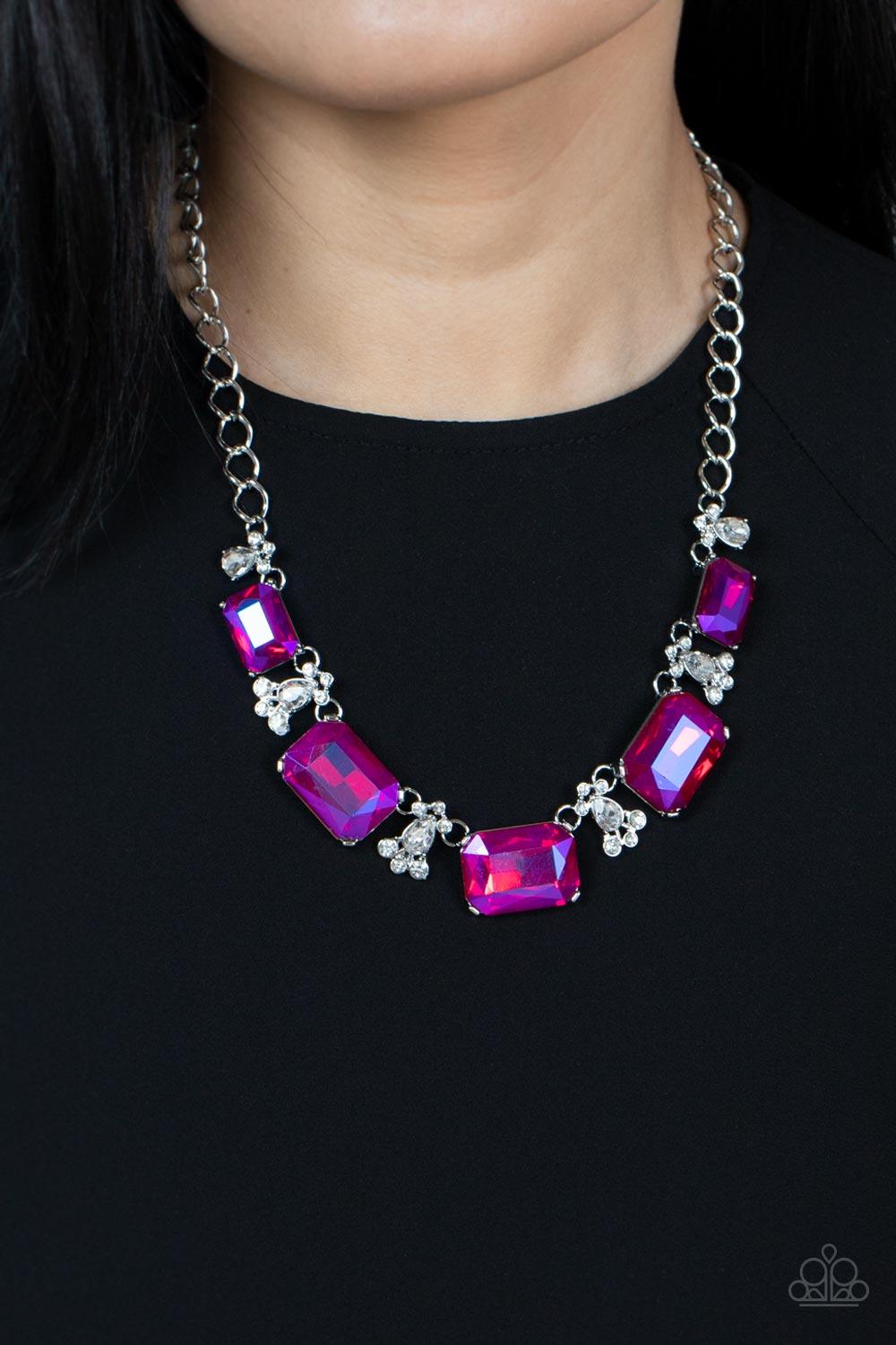 Paparazzi Accessories Flawlessly Famous - Pink Featuring a stellar UV finish, an oversized collection of emerald cut pink rhinestones link with white rhinestone dotted teardrop rhinestone frames below the collar for a jaw-dropping display. Features an adj