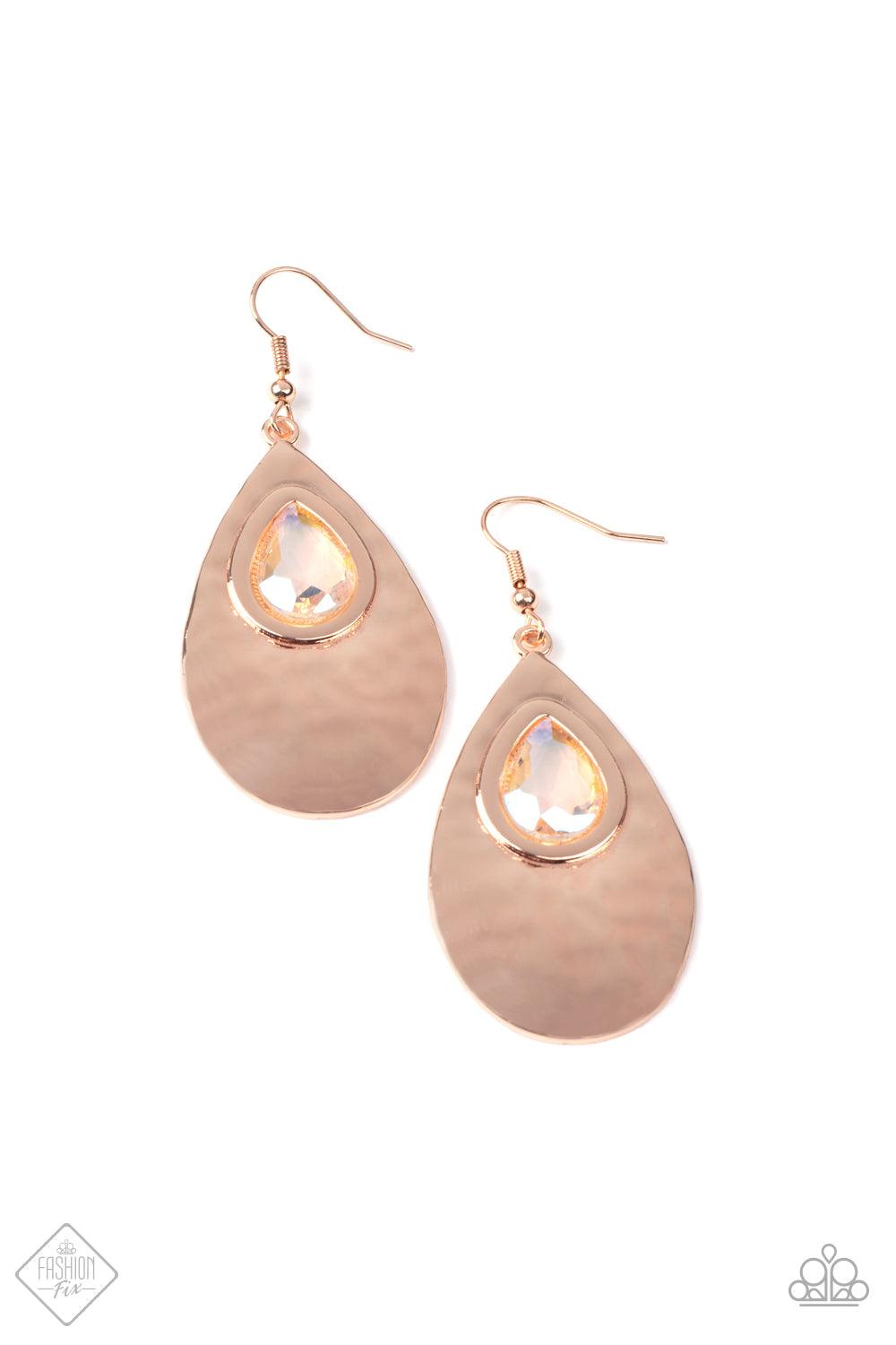 Paparazzi Accessories Tranquil Trove A shiny rose gold or silver teardrop is hammered in texture, creating a radiant display as the light bounces off each beveled surface. A faceted iridescent teardrop gem with Pale Rosette undertones is pressed into the