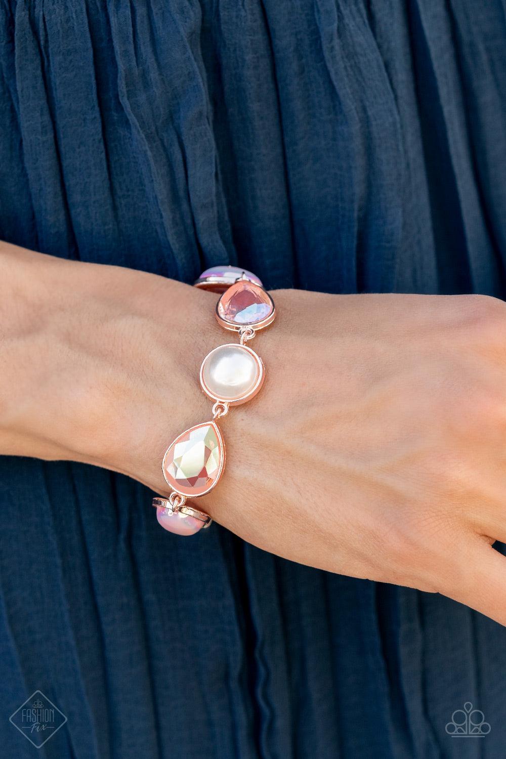 Paparazzi Accessories Nostalgically Nautical - Rose Gold A collection of classic white pearls, Pale Rosette pearls glazed in a reflective finish, and iridescent teardrops wrap around the wrist in an ethereal display. Rose gold frames encase each bead, add