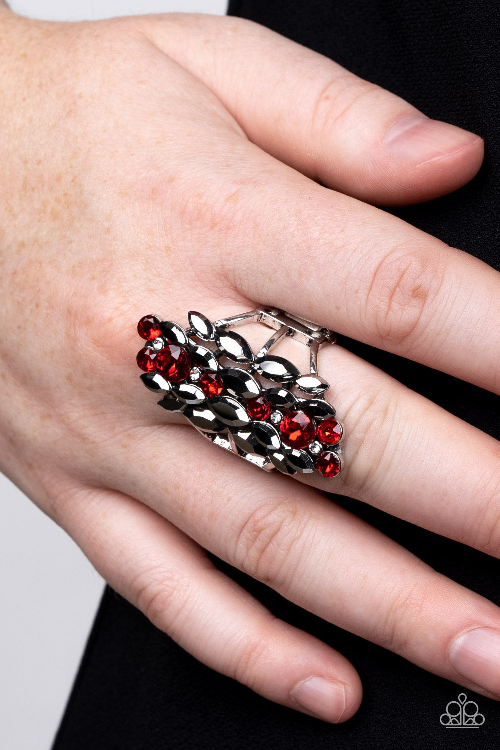 Paparazzi Accessories Smoky Smolder - Red A cascade of dainty white, marquise cut hematite, and round red rhinestones tumble down the finger, coalescing into a smoldering centerpiece. Features a stretchy band for a flexible fit. Sold as one individual rin