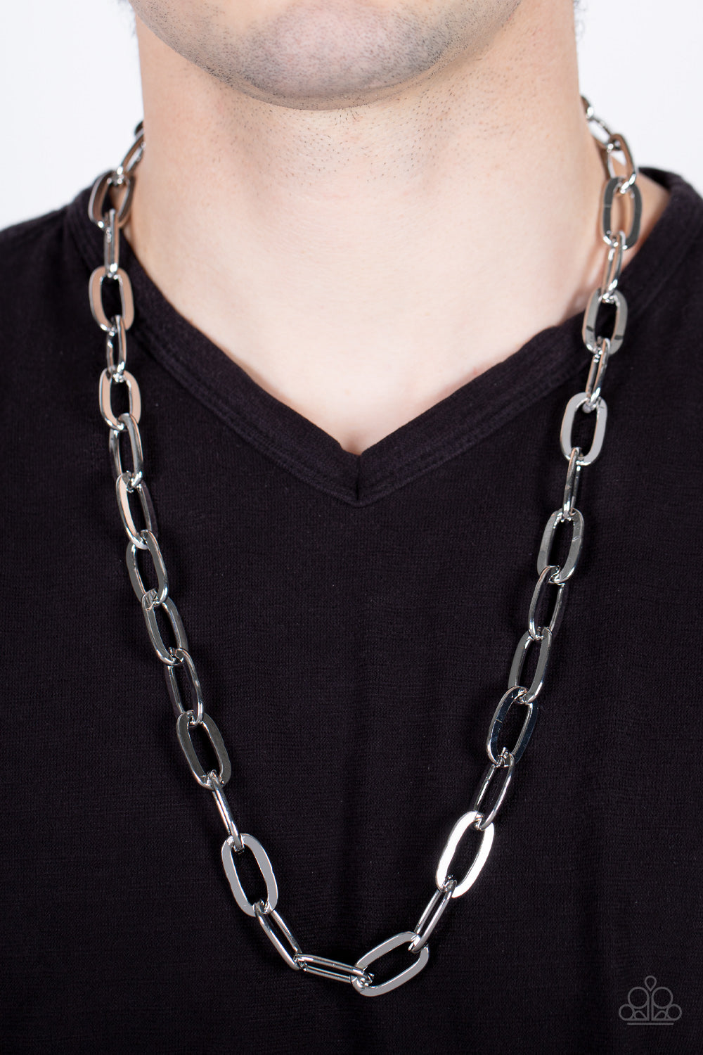 Paparazzi Accessories Urban Quarterback - Silver Featuring a high sheen finish, a shiny collection of oversized silver oval links boldly interlock across the chest for a grit-inspired look. Features an adjustable clasp closure. Sold as one individual neck
