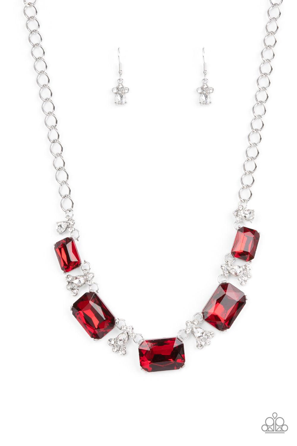 Paparazzi Accessories Flawlessly Famous - Red Featuring a fiery finish, an oversized collection of emerald cut red rhinestones link with rhinestone dotted teardrop rhinestone frames below the collar for a jaw-dropping display. Features an adjustable clasp