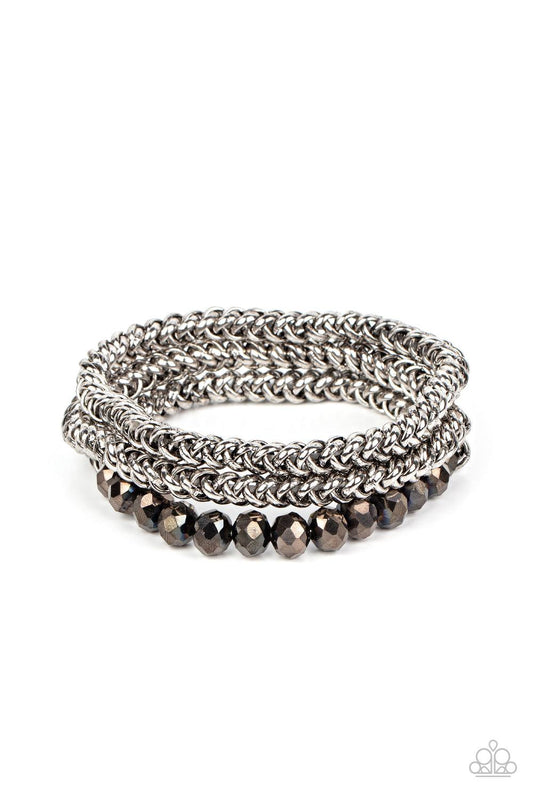 Paparazzi Accessories Gutsy and Glitzy - Silver Threaded along stretchy bands, sections of hematite crystal-like beads and interlocking silver chains layer around the wrist for a dash of glitzy grunge. Sold as one set of three bracelets. Jewelry
