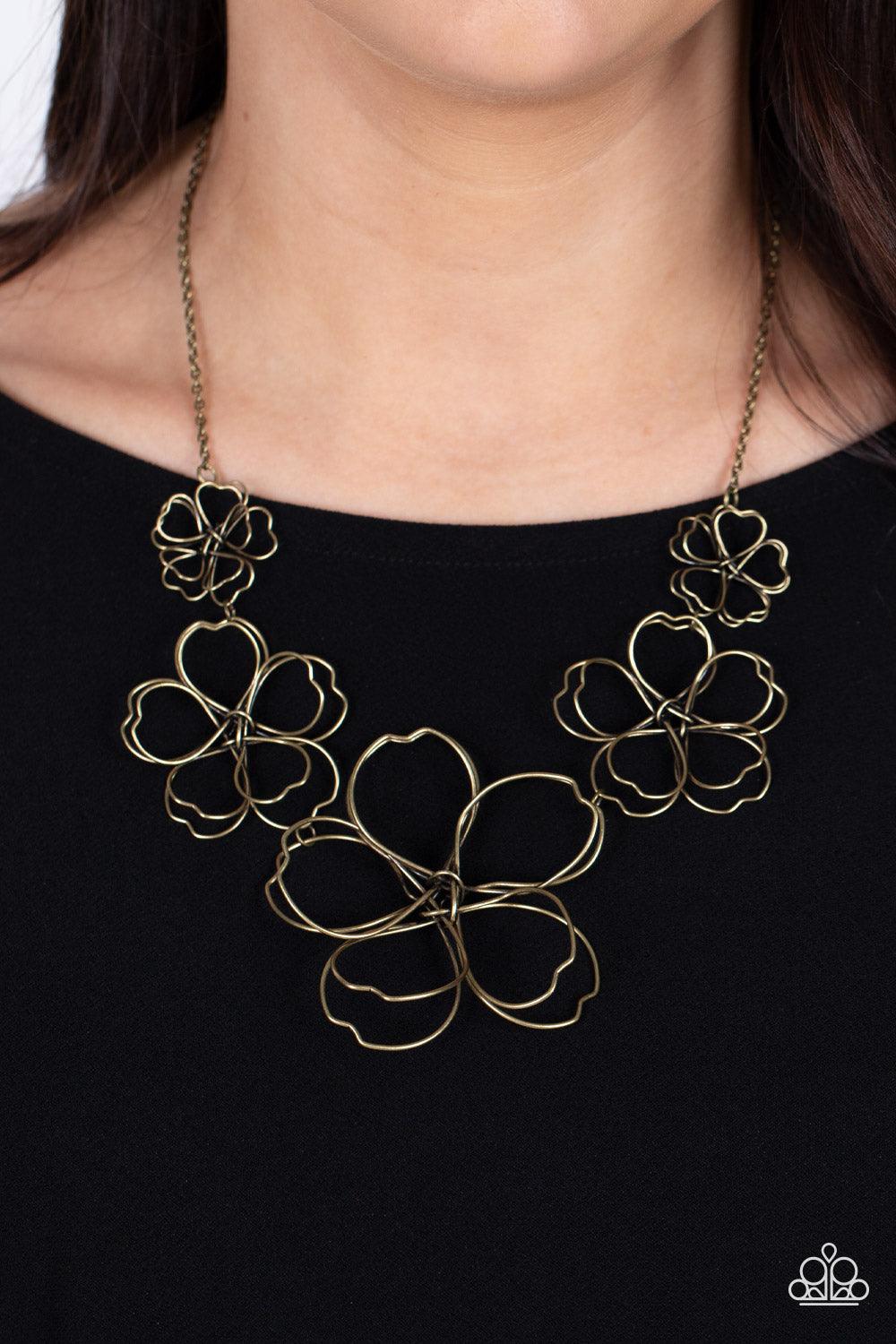 Paparazzi Accessories The Show Must GROW On - Brass Rustic brass wire delicately twists into oversized blossoms. Gradually increasing in size, the 3D frames elegantly pop beneath the collar. Features an adjustable clasp closure. Sold as one individual nec