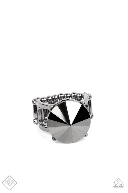 Paparazzi Accessories Showcase Social - Black An oversized hematite rhinestone sits boldly atop two glistening bars of gunmetal, creating a dramatic statement piece. Features a stretchy band for an adjustable fit. Sold as one individual ring. Jewelry