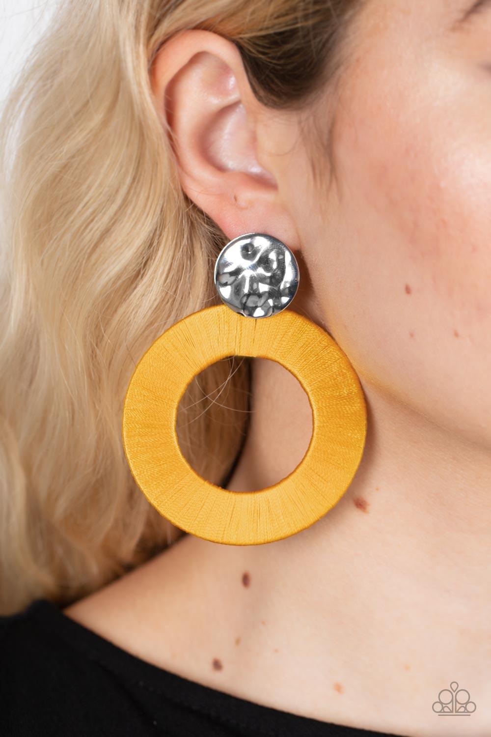 Paparazzi Accessories Strategically Sassy - Yellow A hammered silver disc gives way to an oversized metal hoop wrapped in golden yellow thread, resulting in a modern lure. Earring attaches to a standard post fitting. Sold as one pair of post earrings. Ear