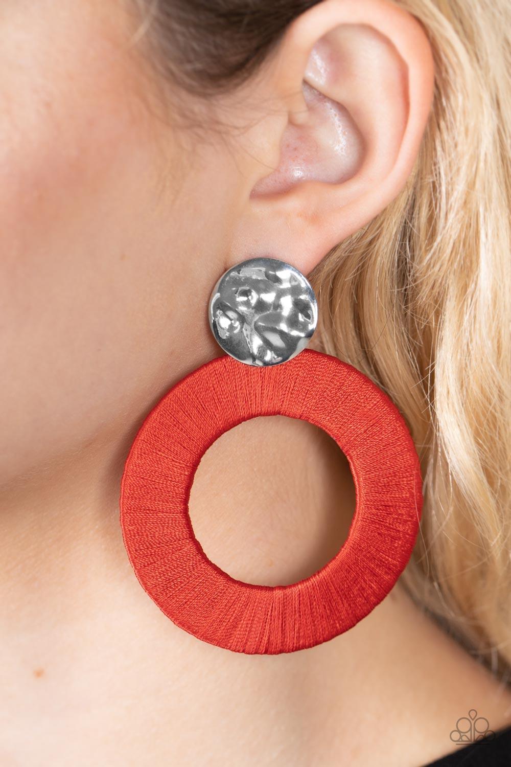 Paparazzi Accessories Strategically Sassy - Red A hammered silver disc gives way to an oversized metal hoop wrapped in fiery red thread, resulting in a modern lure. Earring attaches to a standard post fitting. Sold as one pair of post earrings. Jewelry
