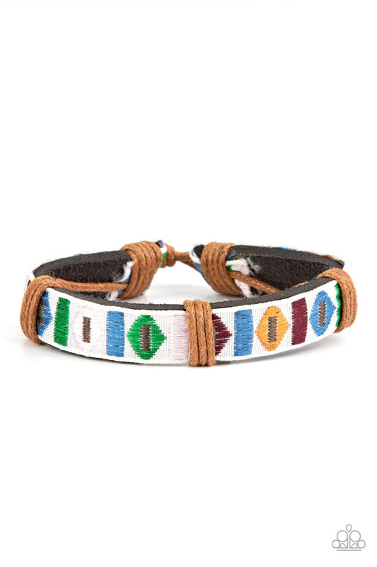 Paparazzi Accessories Textile Trendsetter - Multi A ribbon featuring a colorful geometric textile print is knotted in place across the front of a black leather band, creating a simply seasonal style around the wrist. Features an adjustable sliding knot cl